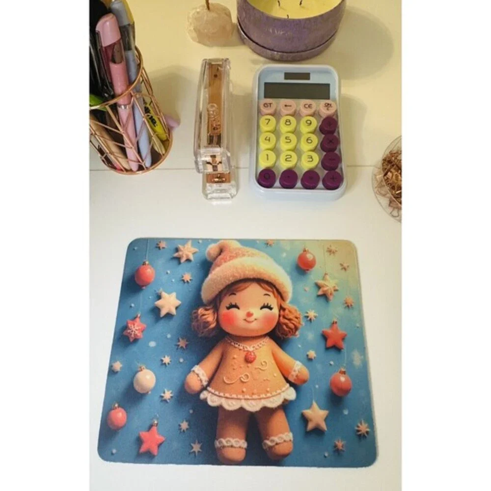 Adorable mouse pad featuring a cute Christmas gingerbread doll design with stars